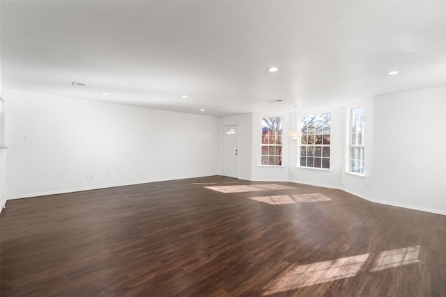 spare room featuring dark wood-type flooring