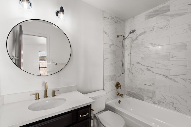 full bathroom featuring tiled shower / bath, vanity, and toilet