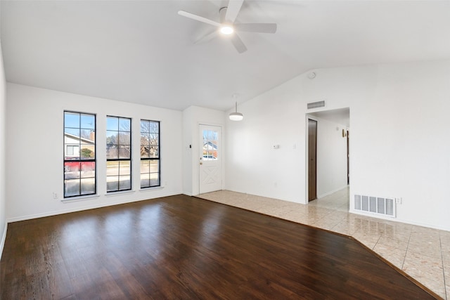 empty room featuring ceiling fan, lofted ceiling, and light hardwood / wood-style floors