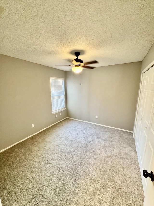 unfurnished bedroom with carpet flooring, a textured ceiling, ceiling fan, and a closet