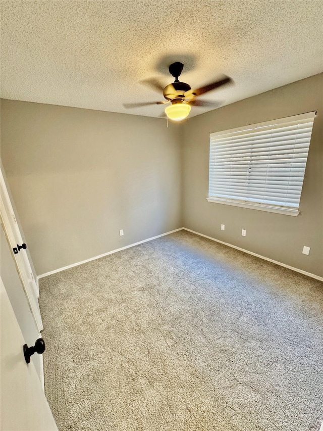 empty room featuring ceiling fan, carpet flooring, and a textured ceiling