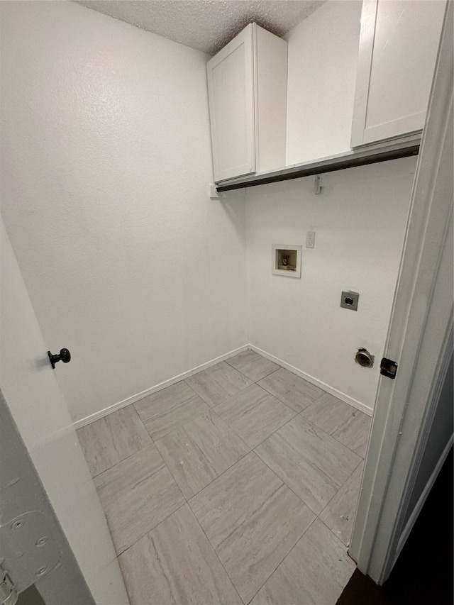 washroom featuring cabinets, washer hookup, hookup for an electric dryer, and a textured ceiling