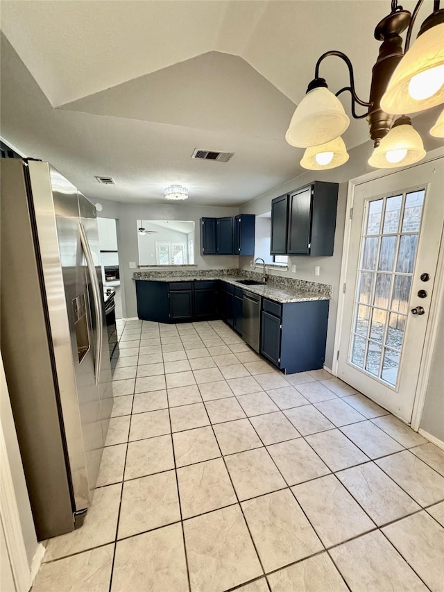 kitchen featuring appliances with stainless steel finishes, sink, light tile patterned floors, and lofted ceiling