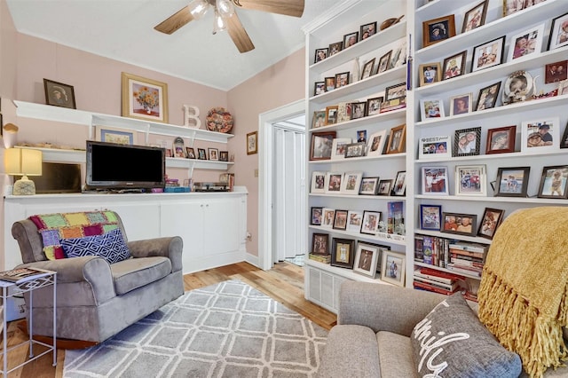 sitting room with wood-type flooring and ceiling fan