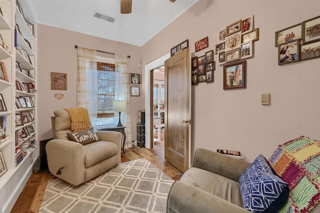 sitting room featuring light hardwood / wood-style floors and ceiling fan