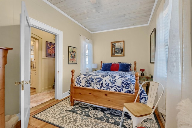 bedroom featuring crown molding, wood ceiling, and hardwood / wood-style floors