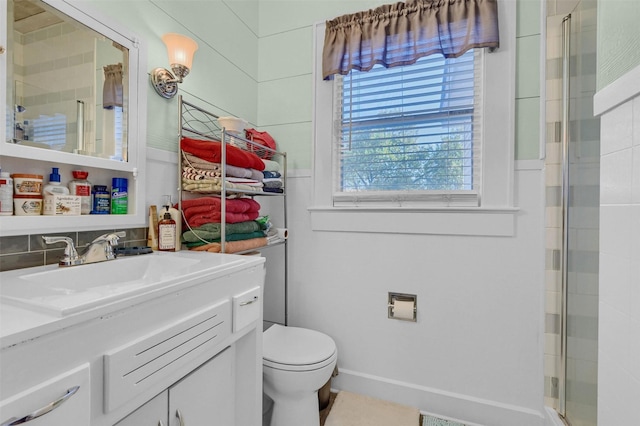 bathroom featuring tasteful backsplash, vanity, an enclosed shower, and toilet