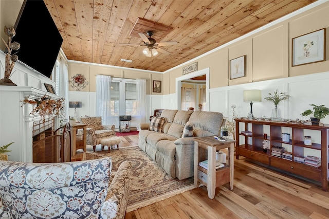 living room with crown molding, light wood-type flooring, ceiling fan, and wood ceiling