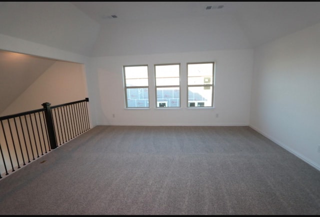 spare room with lofted ceiling and carpet floors