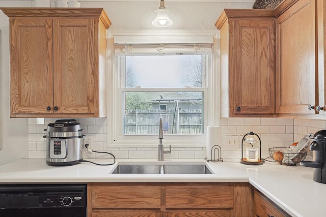 kitchen with sink, backsplash, plenty of natural light, and dishwasher