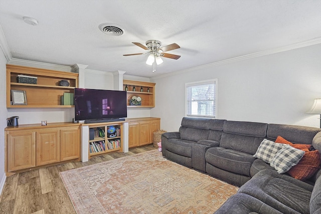 living room with crown molding, light hardwood / wood-style flooring, and ceiling fan