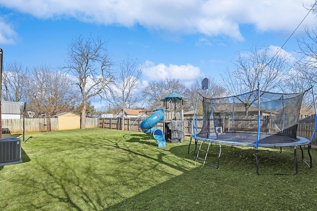 view of yard featuring a playground, central AC, a trampoline, and a shed