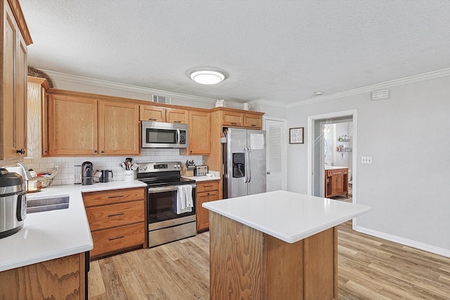 kitchen featuring appliances with stainless steel finishes, backsplash, ornamental molding, a textured ceiling, and a kitchen island