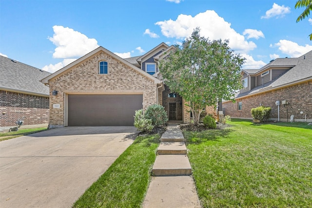 view of front of property featuring a garage and a front lawn