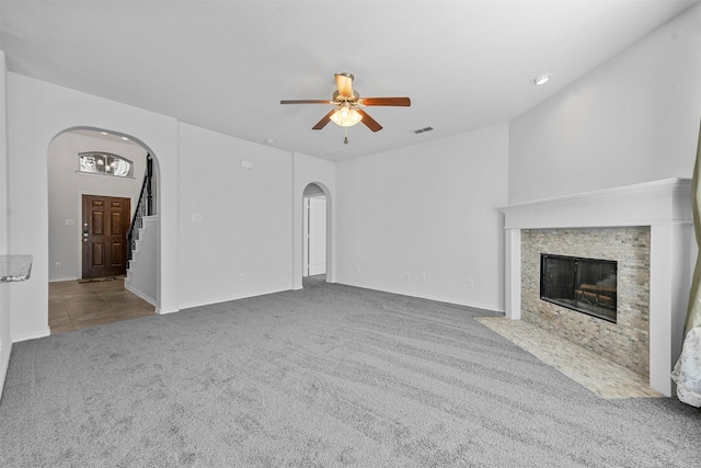 unfurnished living room with ceiling fan and carpet