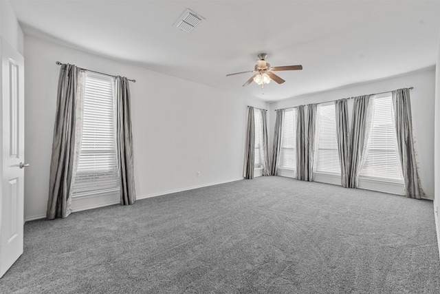 carpeted spare room featuring ceiling fan