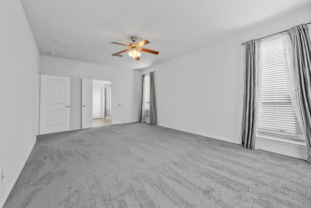 empty room featuring carpet floors and ceiling fan