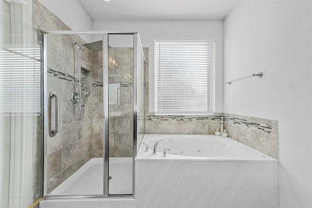 bathroom featuring separate shower and tub