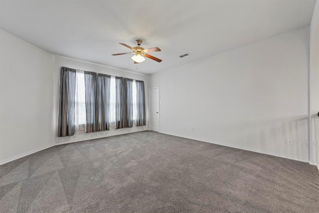 carpeted spare room with ceiling fan