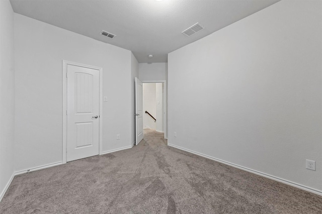 unfurnished bedroom featuring light carpet