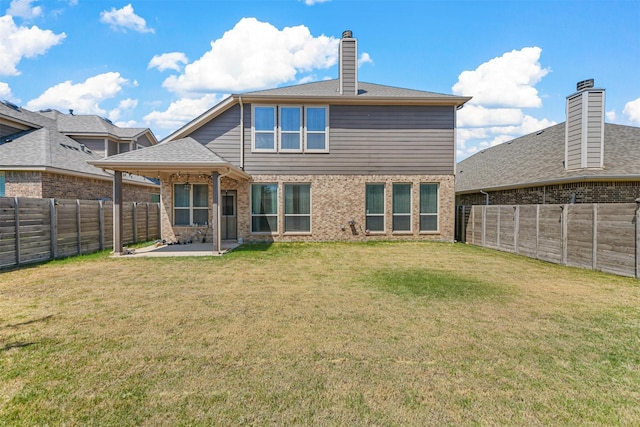 back of property featuring a yard and a patio