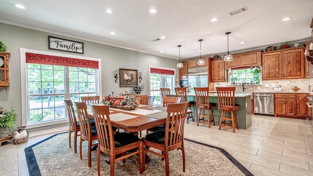 dining space featuring crown molding and sink