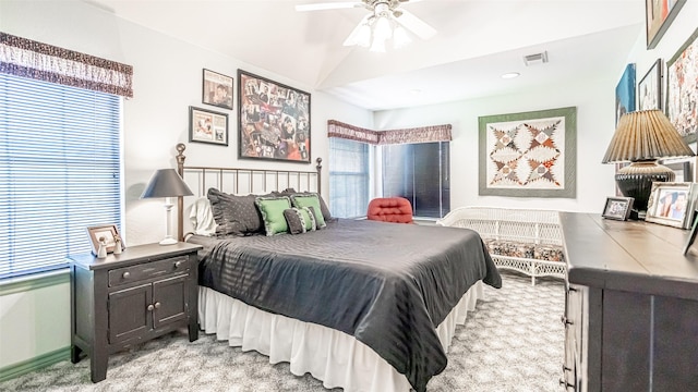 carpeted bedroom featuring lofted ceiling and ceiling fan