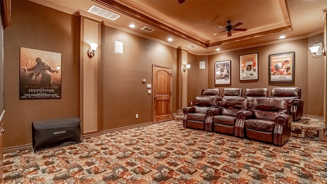 home theater room featuring crown molding, ceiling fan, and a raised ceiling