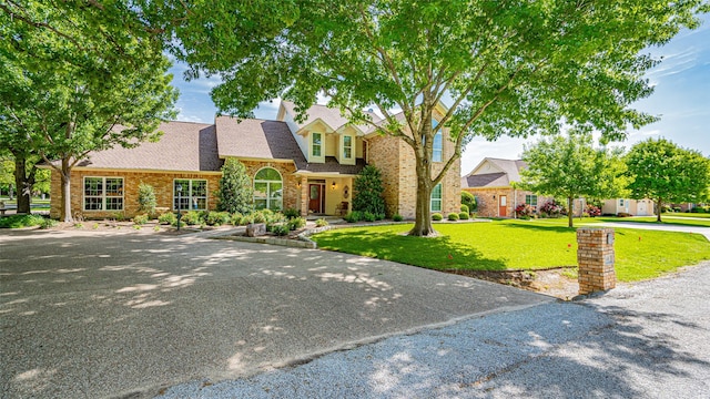 cape cod home featuring a front yard