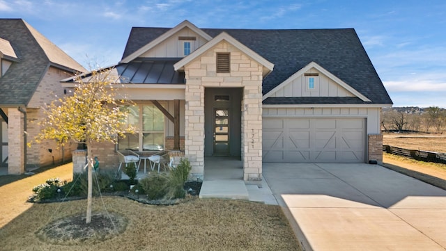 view of front of house with board and batten siding, a standing seam roof, a shingled roof, and concrete driveway