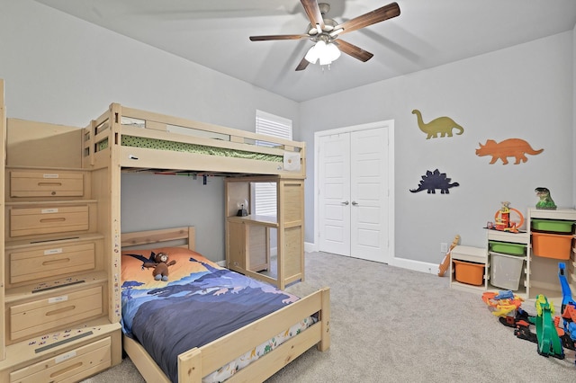 bedroom featuring ceiling fan, a closet, and light carpet