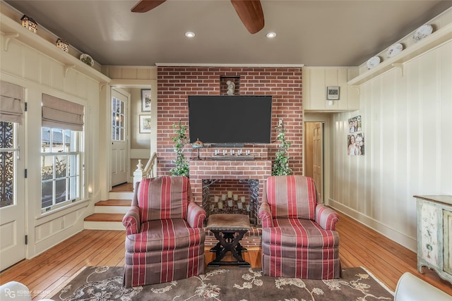 sitting room featuring crown molding, ceiling fan, and light wood-type flooring