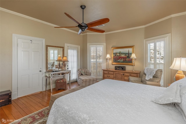 bedroom featuring wood-type flooring, ornamental molding, and ceiling fan