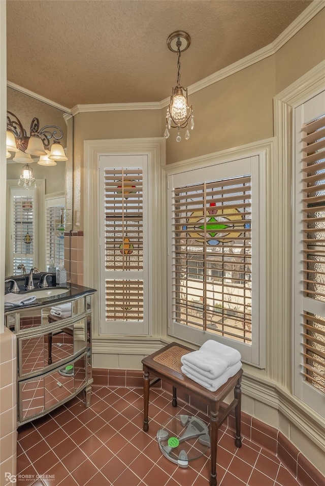 living area featuring a healthy amount of sunlight, tile patterned floors, and a textured ceiling