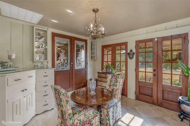 dining space featuring an inviting chandelier and french doors