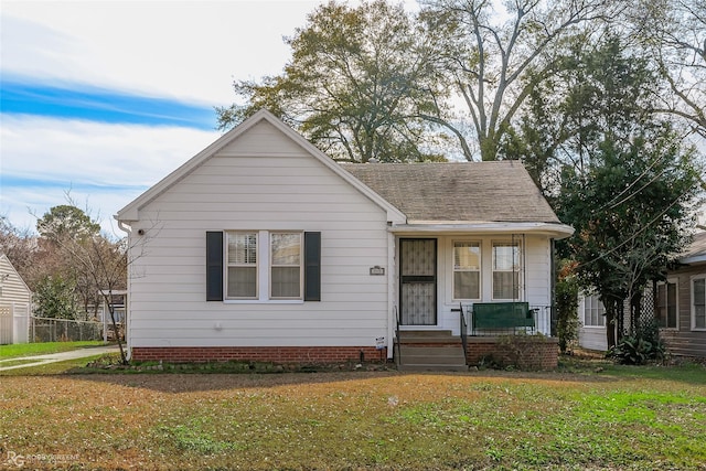 bungalow-style house featuring a front yard