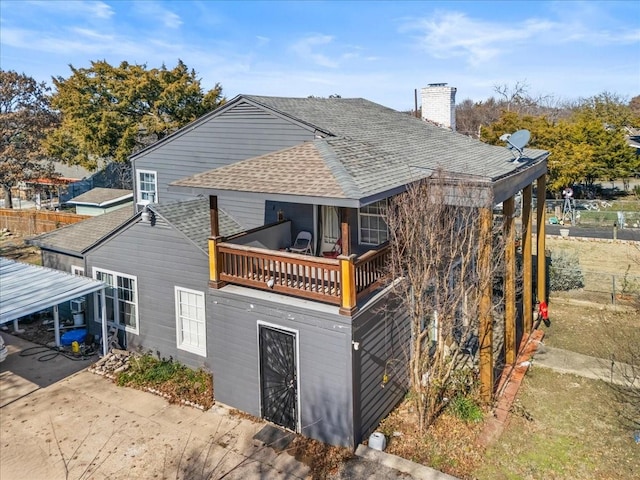 rear view of property featuring a balcony