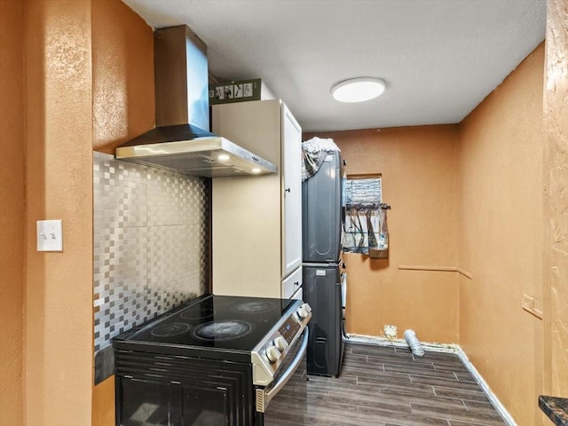 kitchen with tasteful backsplash, wall chimney range hood, electric range, and dark hardwood / wood-style floors