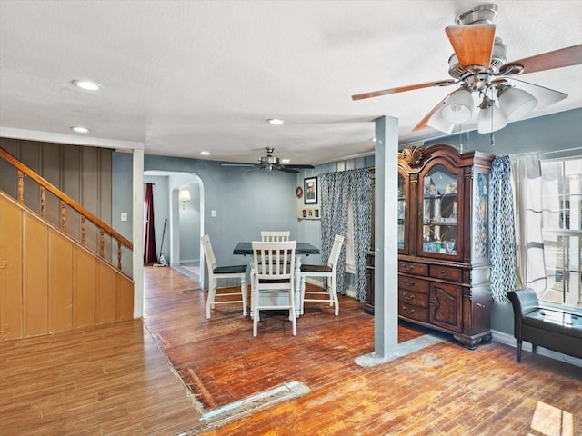 unfurnished dining area with wood-type flooring, a textured ceiling, and ceiling fan