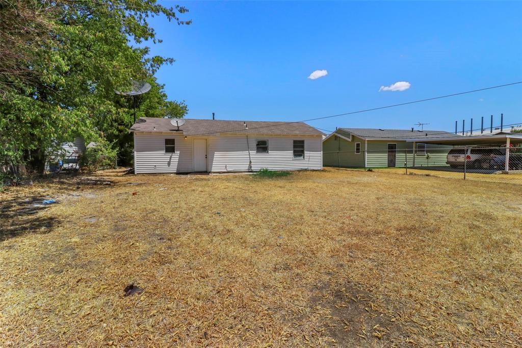 rear view of house with a yard