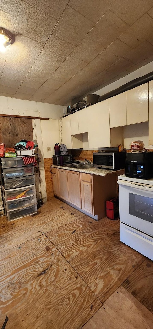 kitchen featuring white electric range oven and sink