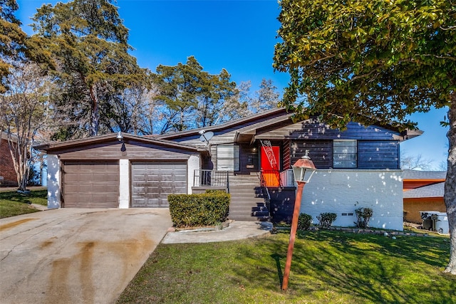 ranch-style house with a garage and a front lawn