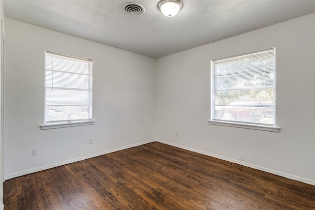 empty room featuring dark wood-type flooring