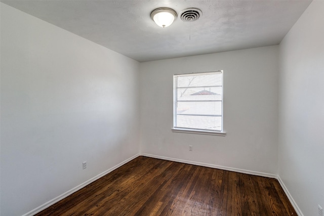 empty room with dark hardwood / wood-style floors