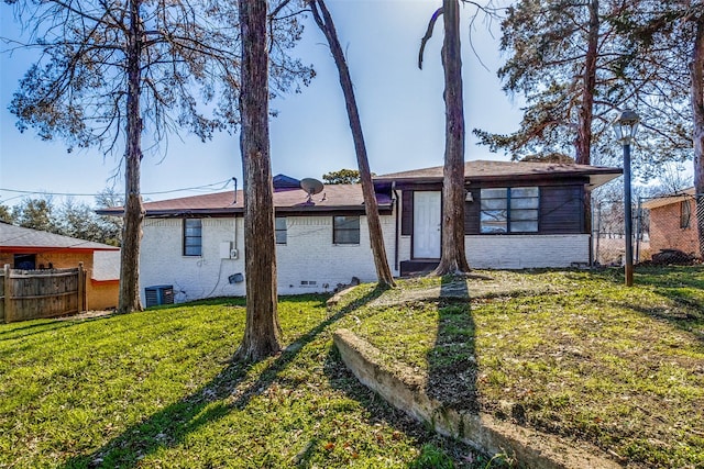 back of house featuring central AC and a lawn