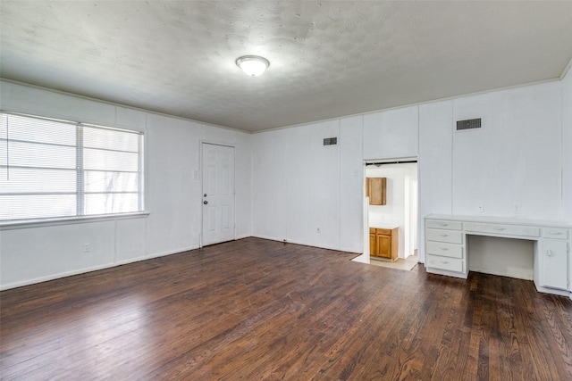 interior space with dark wood-type flooring and a textured ceiling