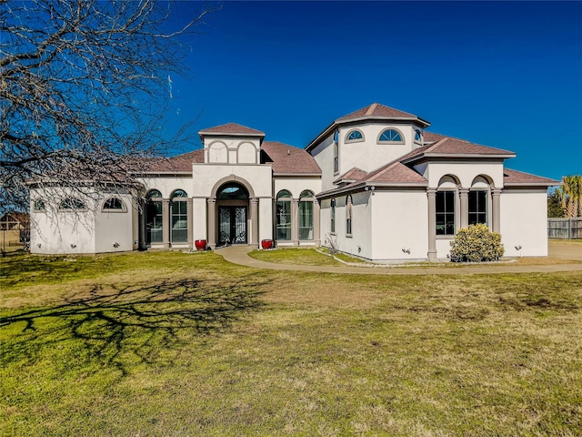 mediterranean / spanish home featuring a front lawn