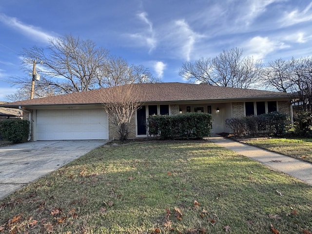 single story home featuring a garage and a front lawn