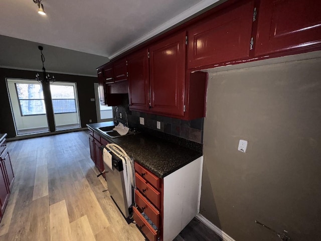 kitchen featuring sink, dishwasher, backsplash, ornamental molding, and light hardwood / wood-style floors