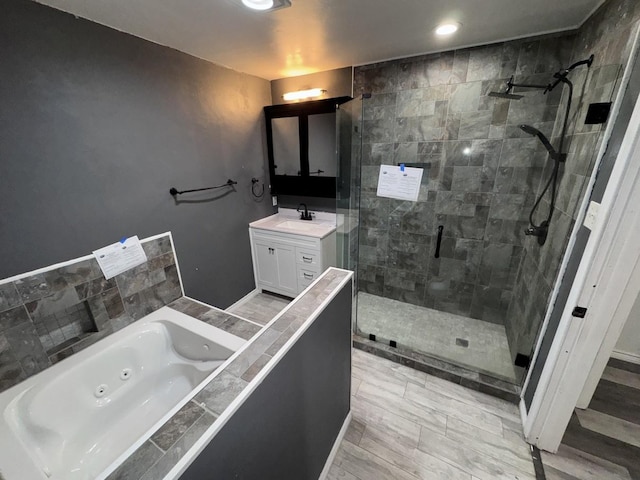 bathroom featuring vanity and shower with separate bathtub